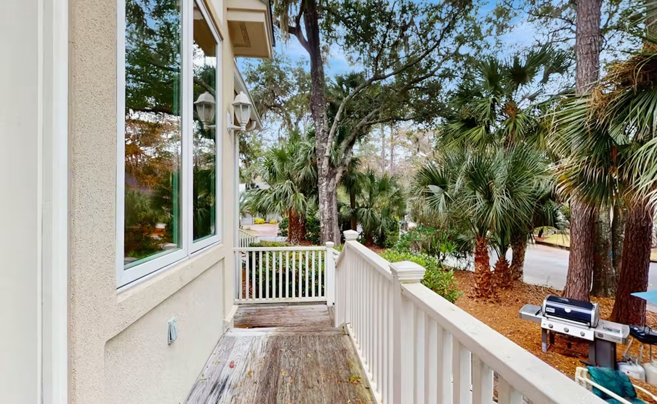 Step onto your private balcony and breathe in the tropical paradise surrounding you, with lush palms swaying gently in the breeze.