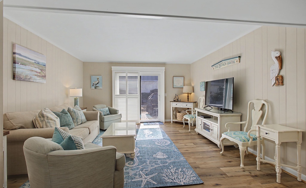 Sink into coastal comfort in your beautifully appointed living room, where soft beach tones and charming nautical touches create the perfect seaside retreat.