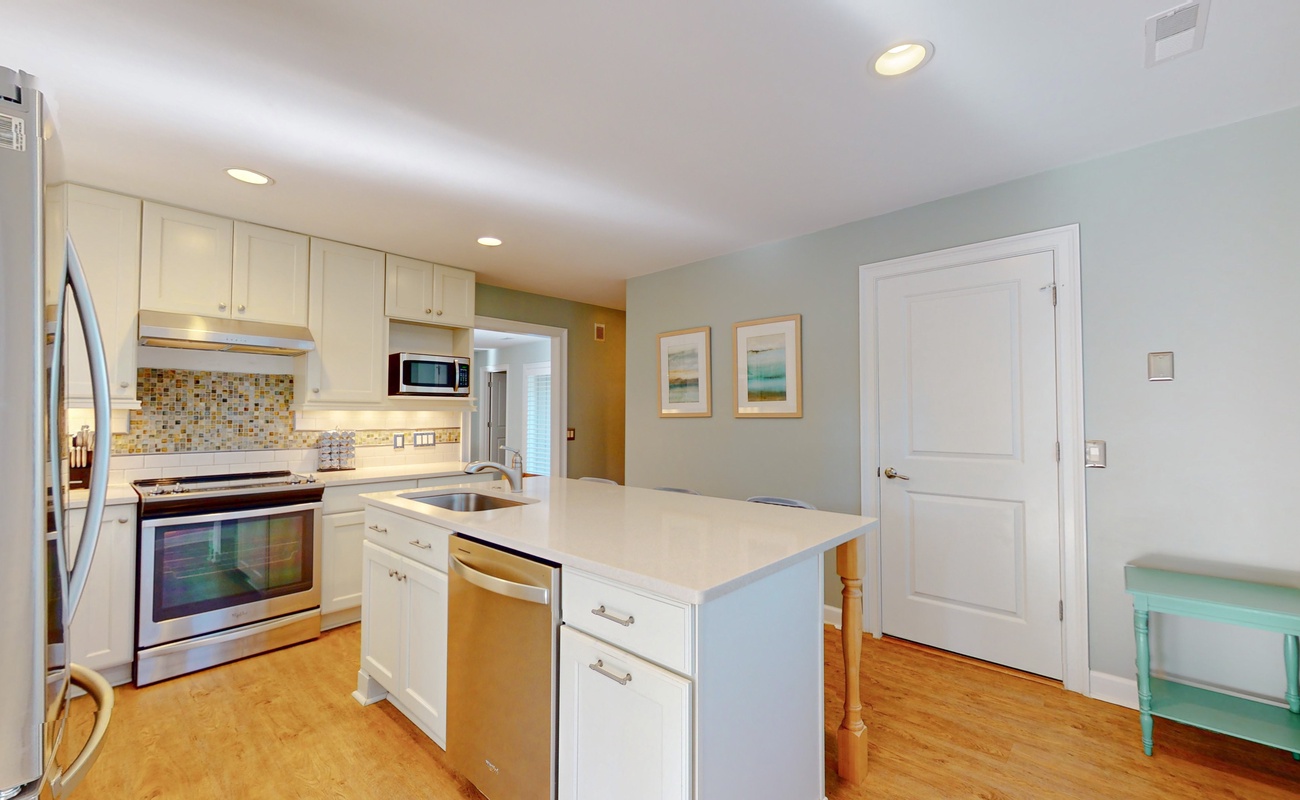 Your fully equipped kitchen features modern appliances, sleek countertops, and bright open design perfect for cooking memorable meals during your stay.