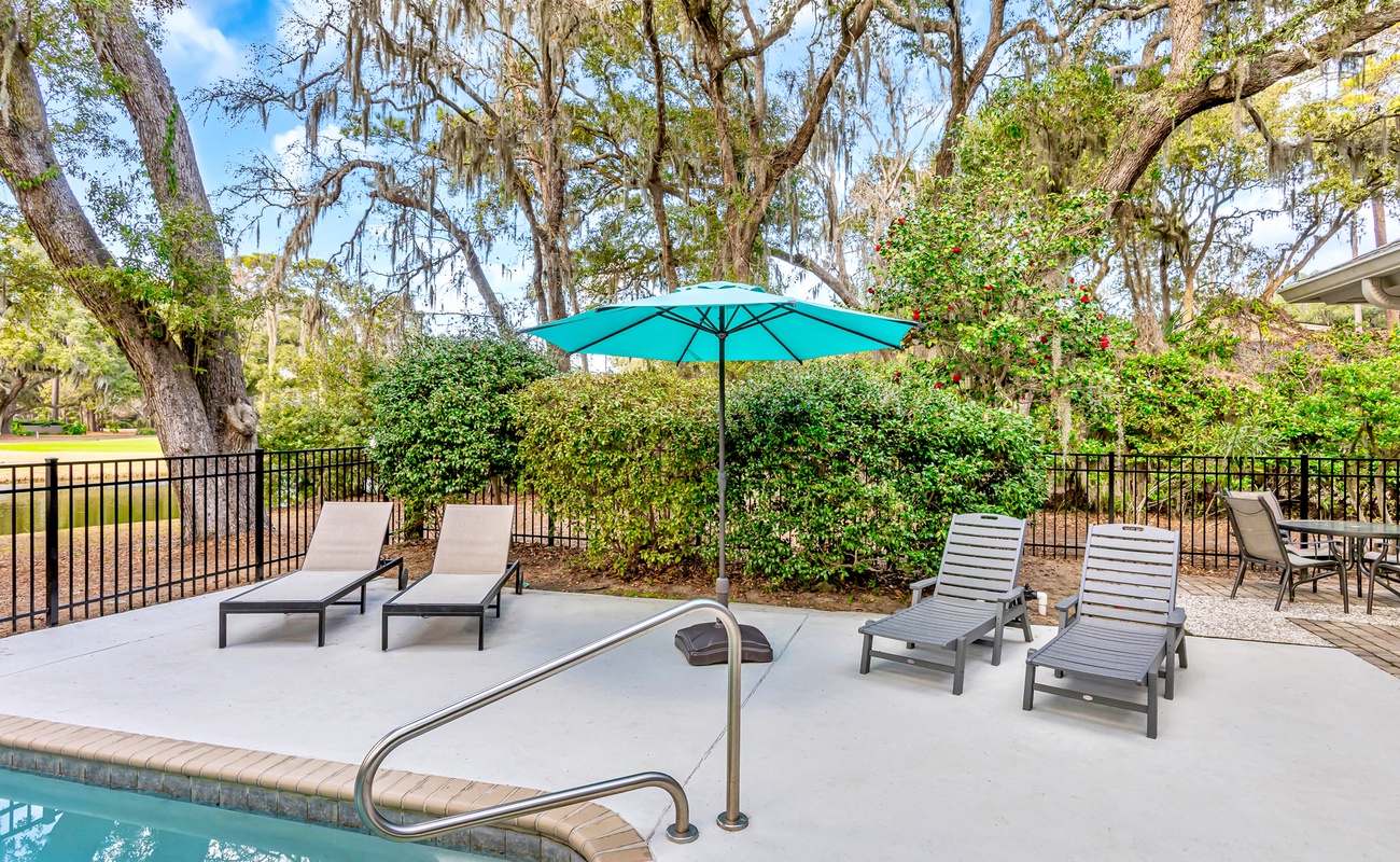 Unwind poolside under your private umbrella, surrounded by towering oaks draped in Spanish moss.