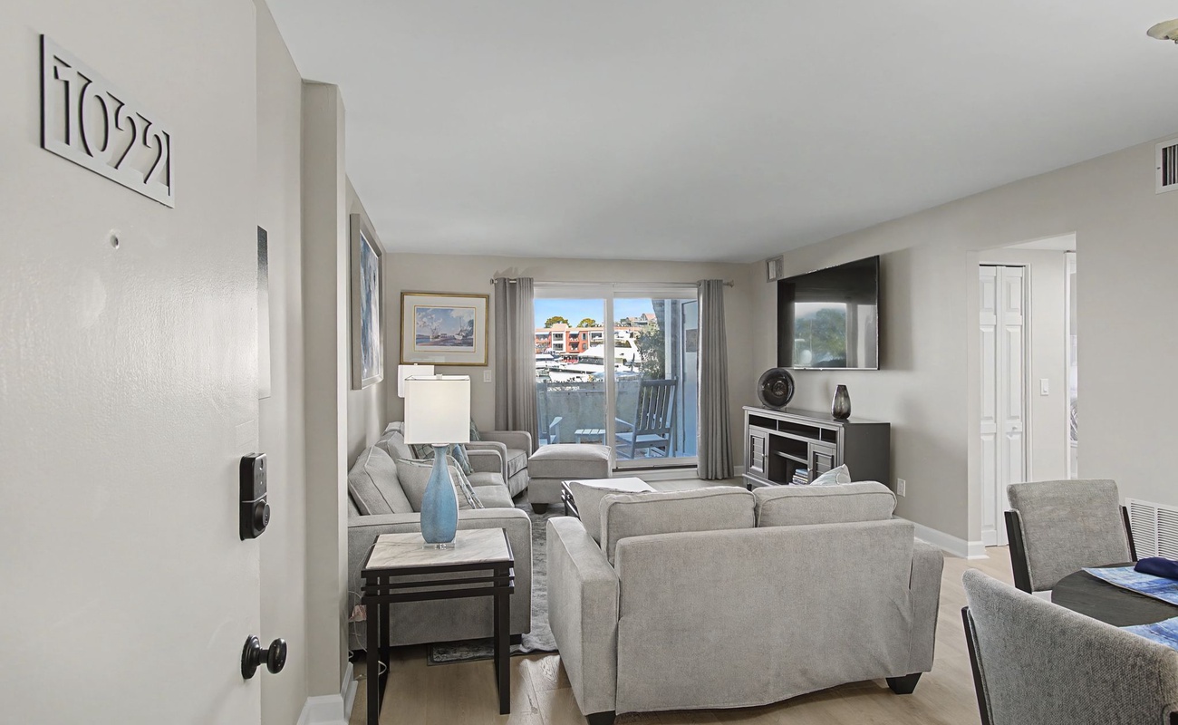 Your bright living space features plush seating and waterfront views through large windows, perfect for relaxing after exploring.