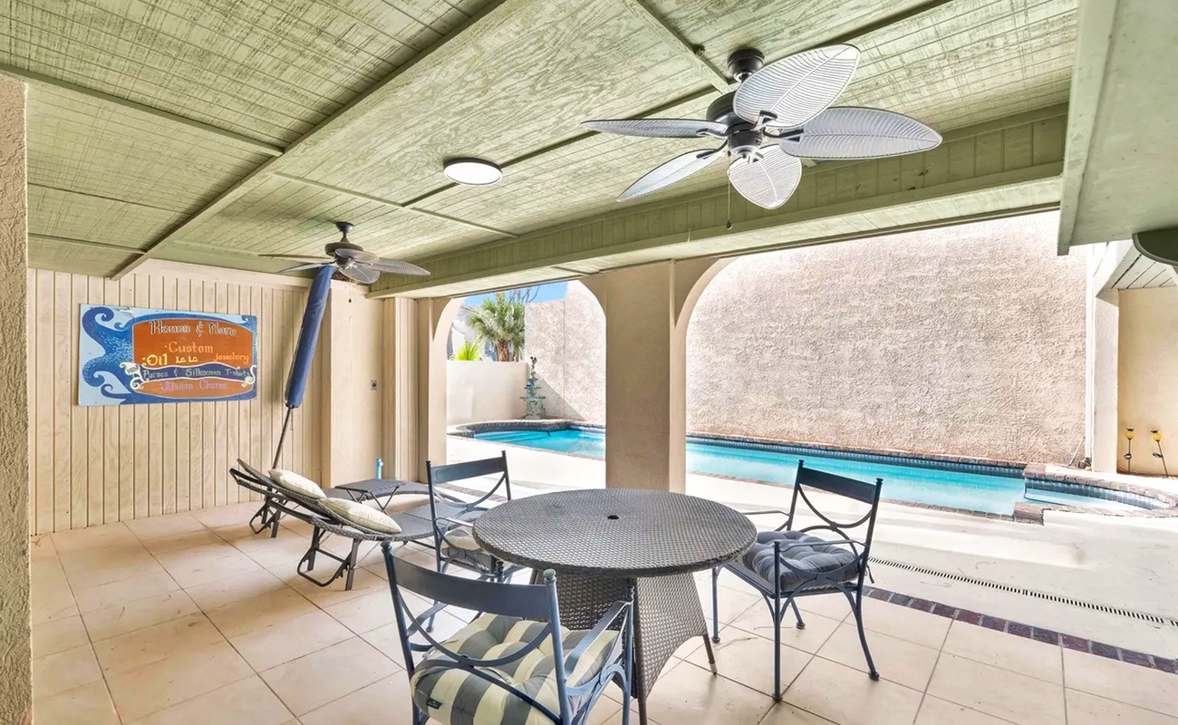 Relax at your private covered patio with pool views, complete with ceiling fans and outdoor dining for perfect poolside meals.
