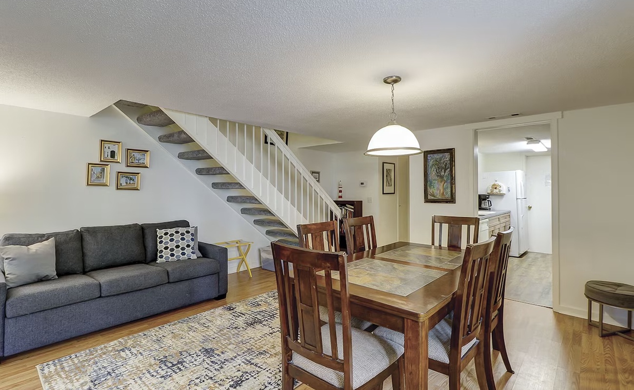 Relax in your spacious open-concept living area with comfortable seating, elegant dining space, and easy access to the fully equipped kitchen.