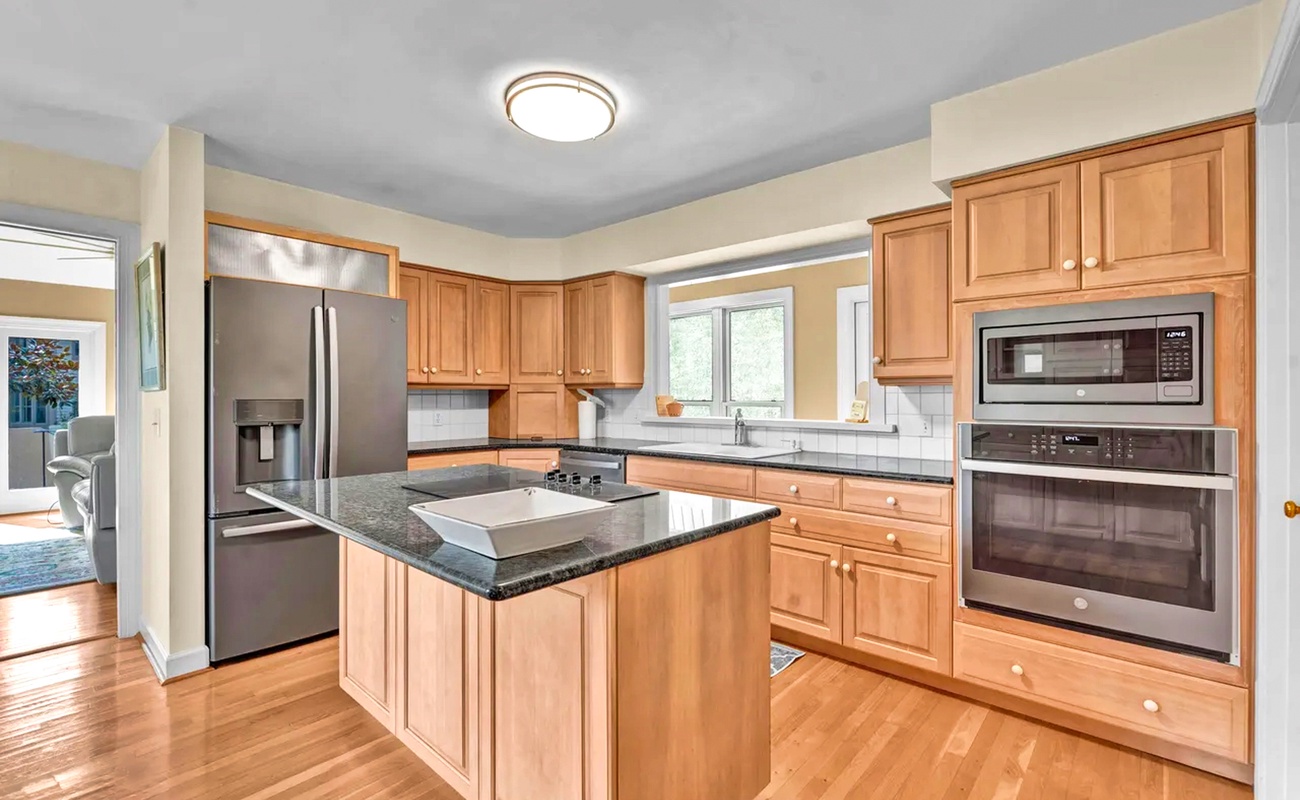 Your gourmet kitchen awaits with granite counters, stainless appliances, and a spacious island perfect for cooking memorable meals together.