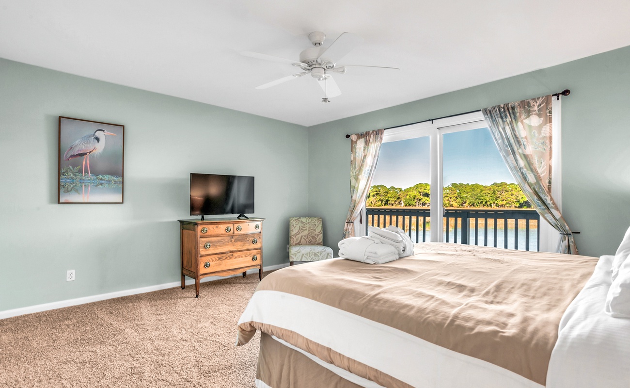 Wake up to stunning water views from your peaceful bedroom, where soft morning light and soothing colors create the perfect retreat.