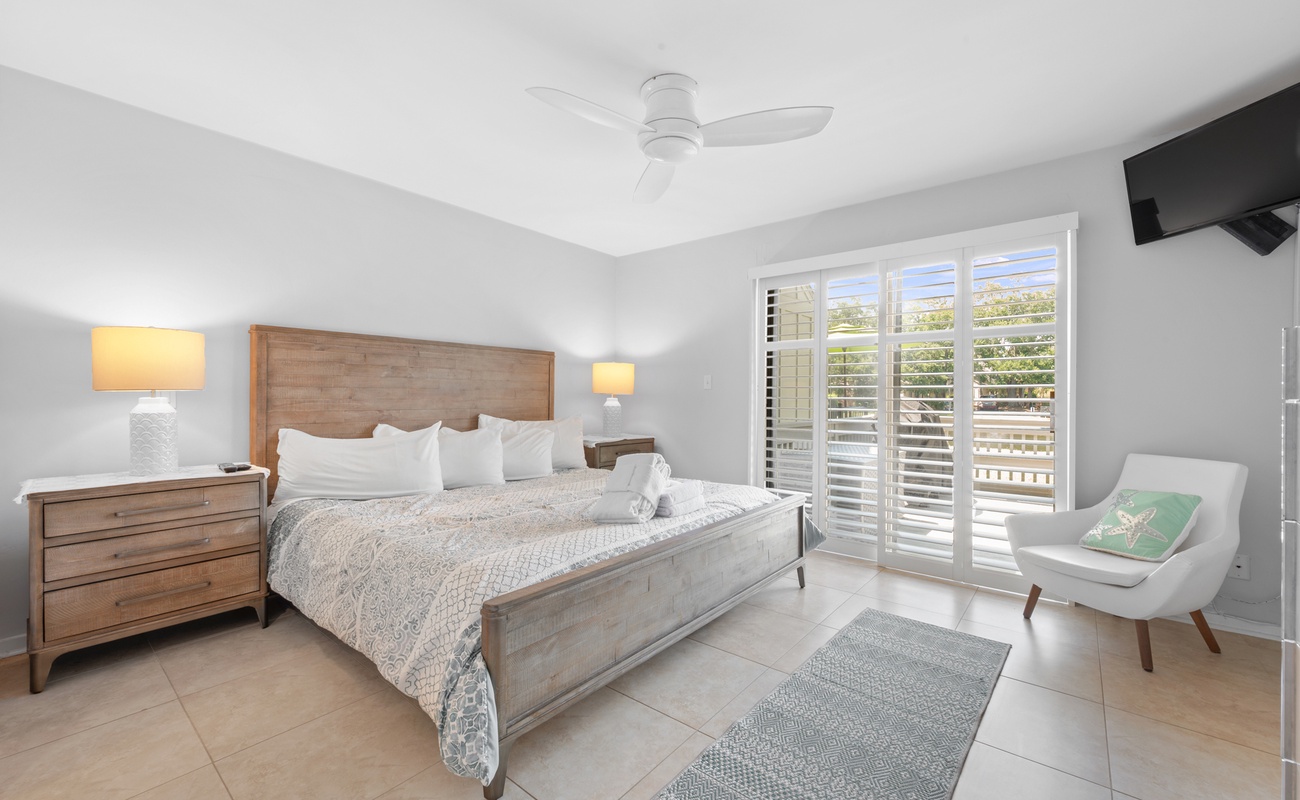 Primary Suite with King Bed, En-Suite Bathroom, and Access to Private Porch