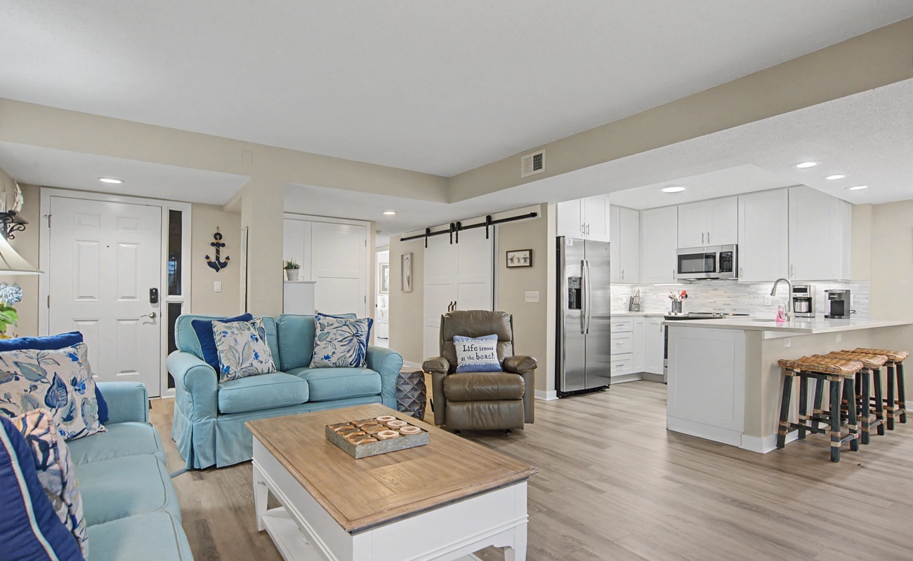 Your coastal-inspired retreat welcomes you with plush teal seating and a gleaming kitchen, perfect for relaxing and creating memories together.