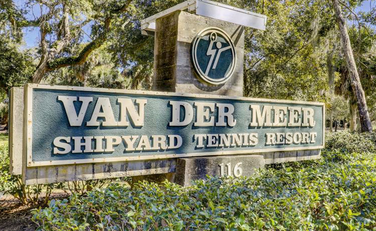 Van Der Meer Shipyard Tennis Resort entrance sign surrounded by lush landscaping marks arrival at this distinctive destination.