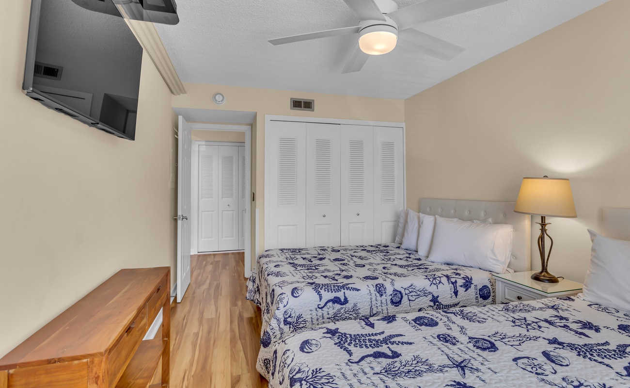 Relax in your bright bedroom with twin beds, soft linens, and coastal charm that promises restful nights.