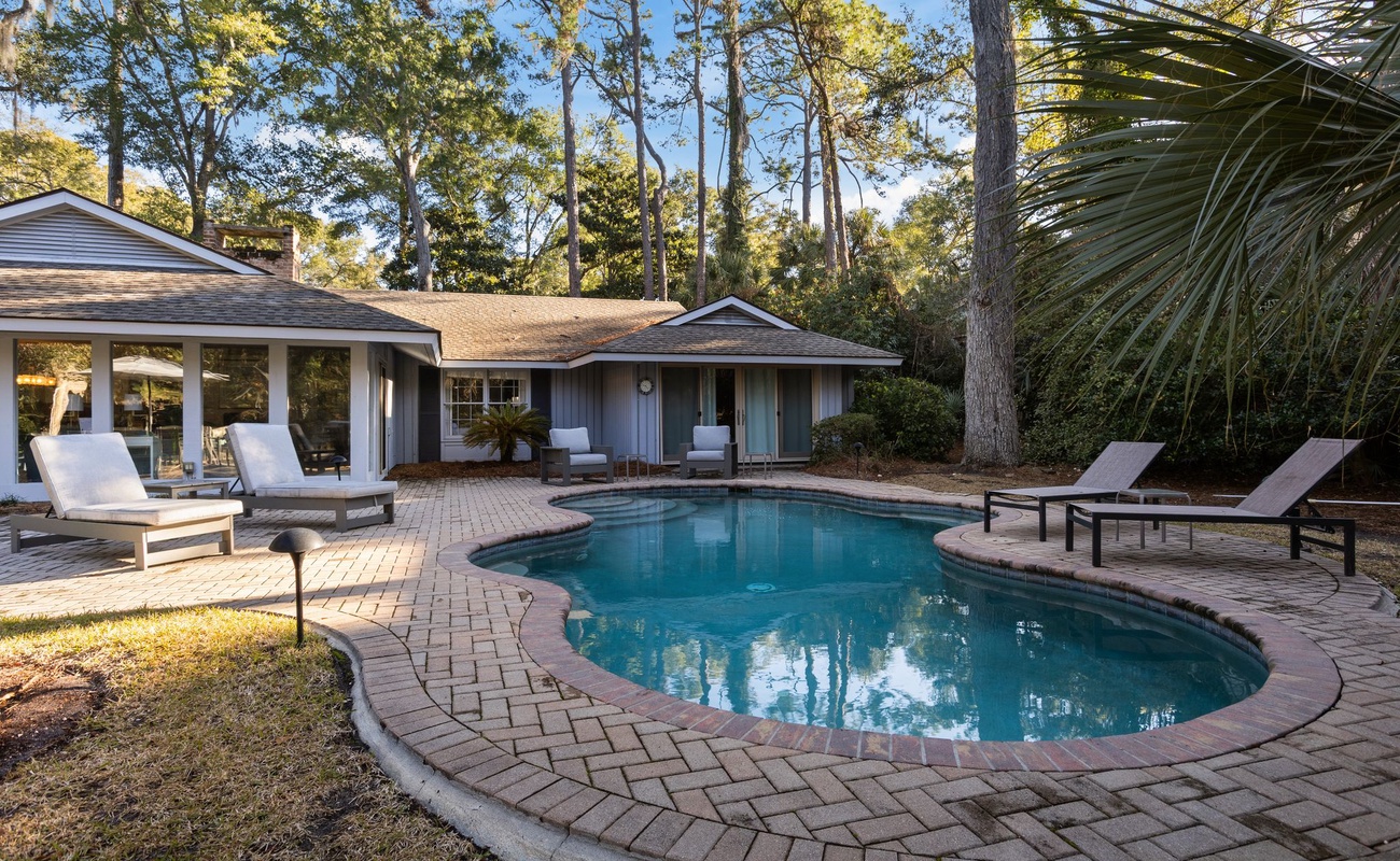 Dive into your private oasis where crystal-clear waters await surrounded by swaying palms and comfortable loungers for ultimate relaxation.