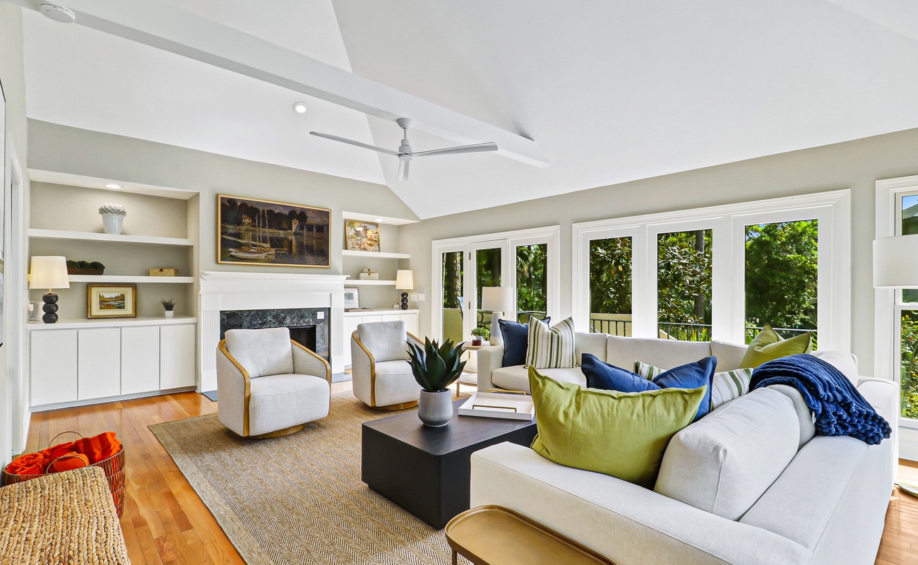 Sink into your elegant living room where natural light floods through floor-to-ceiling windows, creating the perfect space to unwind.