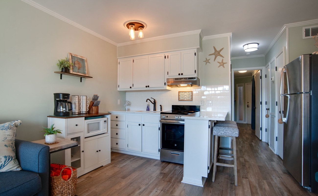 Your fully equipped kitchen features modern appliances and charming coastal touches, perfect for preparing meals during your stay.