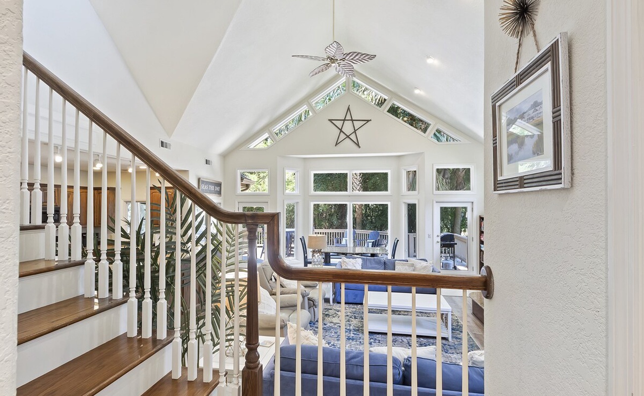 Step into your bright, airy living space where soaring ceilings and abundant windows create a perfect retreat for relaxation and connection.