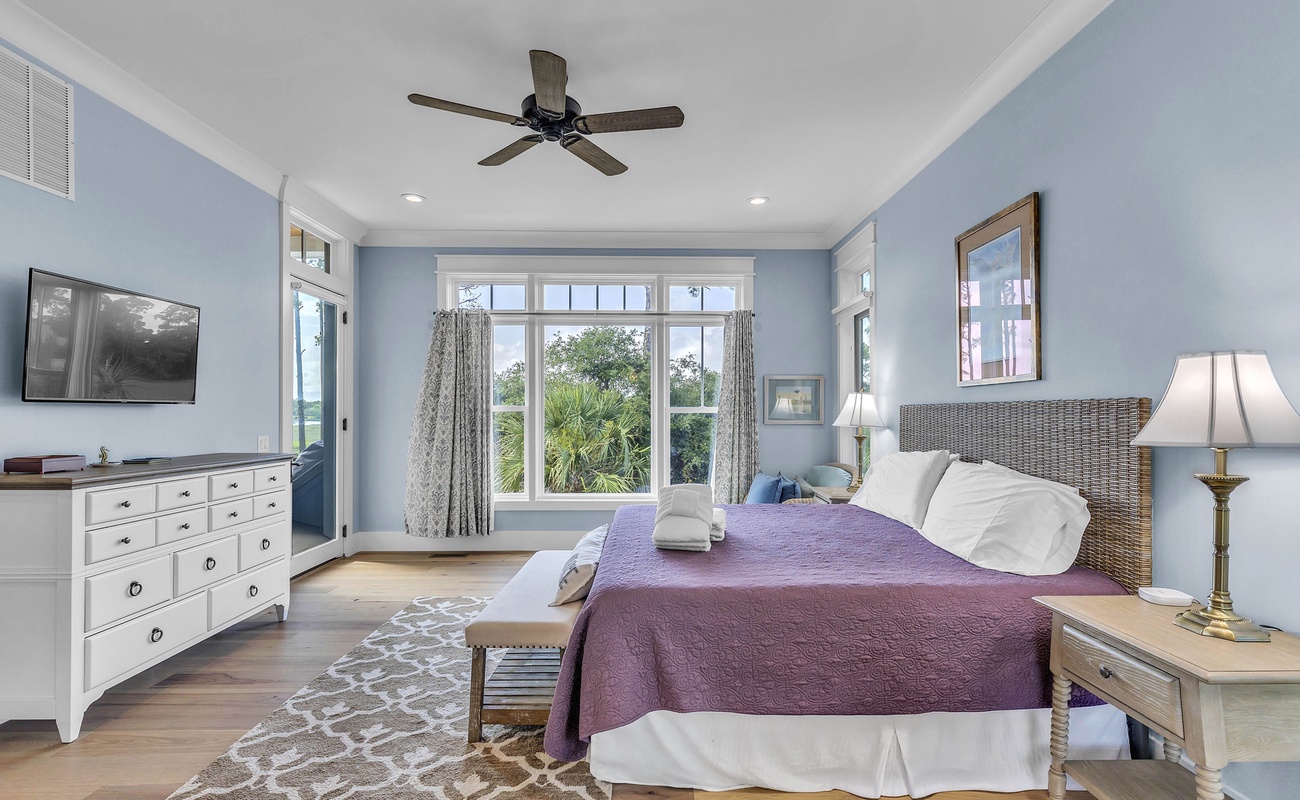 Main Floor Primary Suite with King Bed, En-Suite Bathroom, and Balcony Access