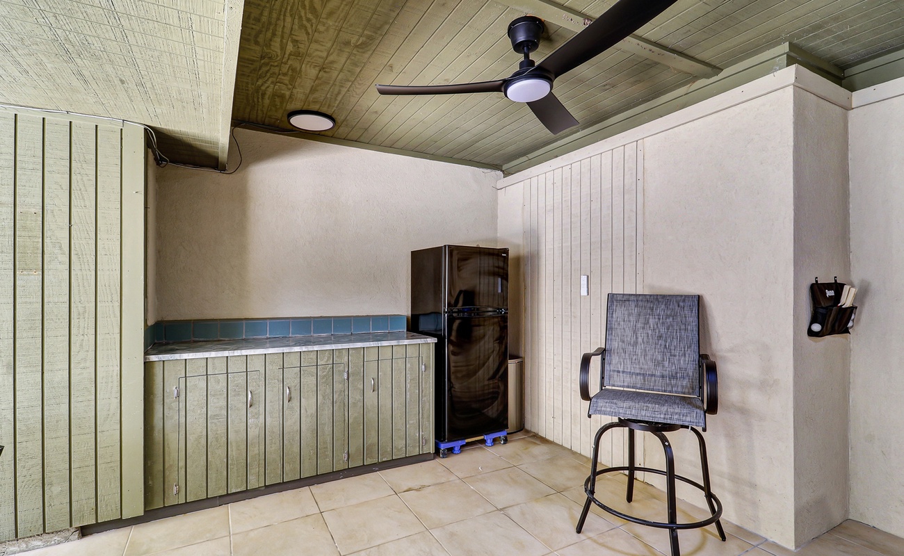 Convenient ground-level refreshment area, perfect for grabbing a cold drink and taking a break between poolside fun and outdoor games.