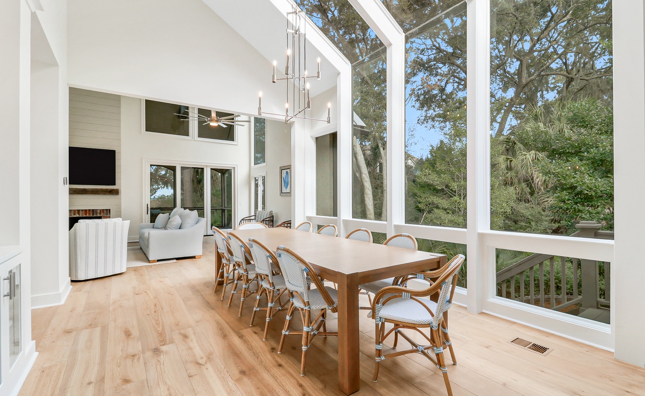 Your bright dining space flows seamlessly into the living area, perfect for memorable meals with sweeping tree views through floor-to-ceiling windows.