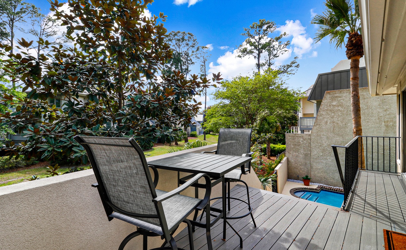 Your private deck overlooks lush gardens, where morning coffee tastes better surrounded by tropical greenery and peaceful views.