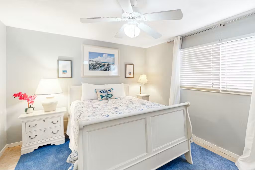 Drift off in your serene bedroom with coastal charm, complete with soft linens and gentle ceiling fan breeze.