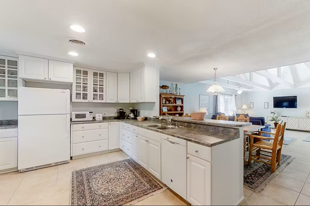 Your fully equipped kitchen features granite countertops, modern appliances, and an open layout perfect for preparing meals and gathering with family.