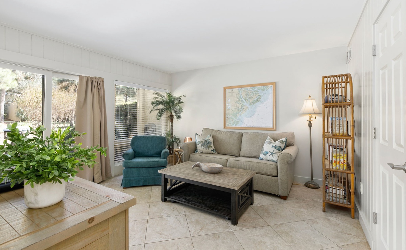 Sink into this bright living room where natural light streams through large windows, creating the perfect spot for your morning coffee or evening unwind.