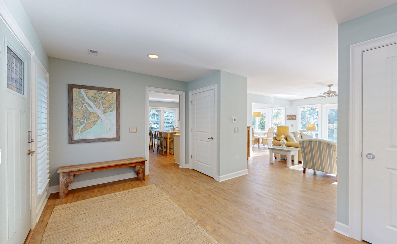 Step into your welcoming entryway with warm hardwood floors and coastal-inspired decor that sets the tone for your relaxing getaway.