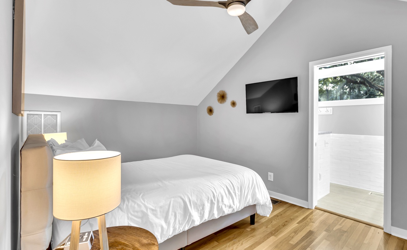 Drift off to sleep in your cozy attic bedroom, where vaulted ceilings and warm wood floors create a peaceful sanctuary.