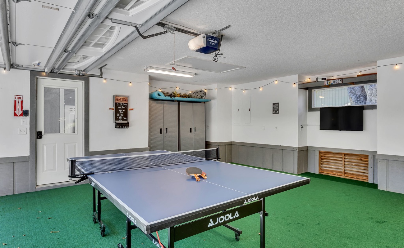 Your private game room awaits with ping pong fun, cozy string lights, and entertainment for memorable evenings with friends and family.