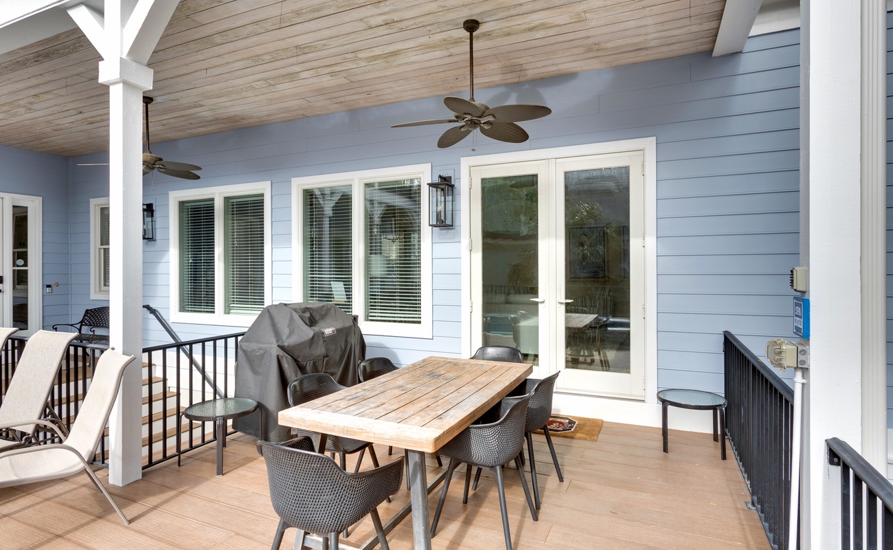 Unwind on your private covered deck with dining space, ceiling fans, and peaceful views through French doors.