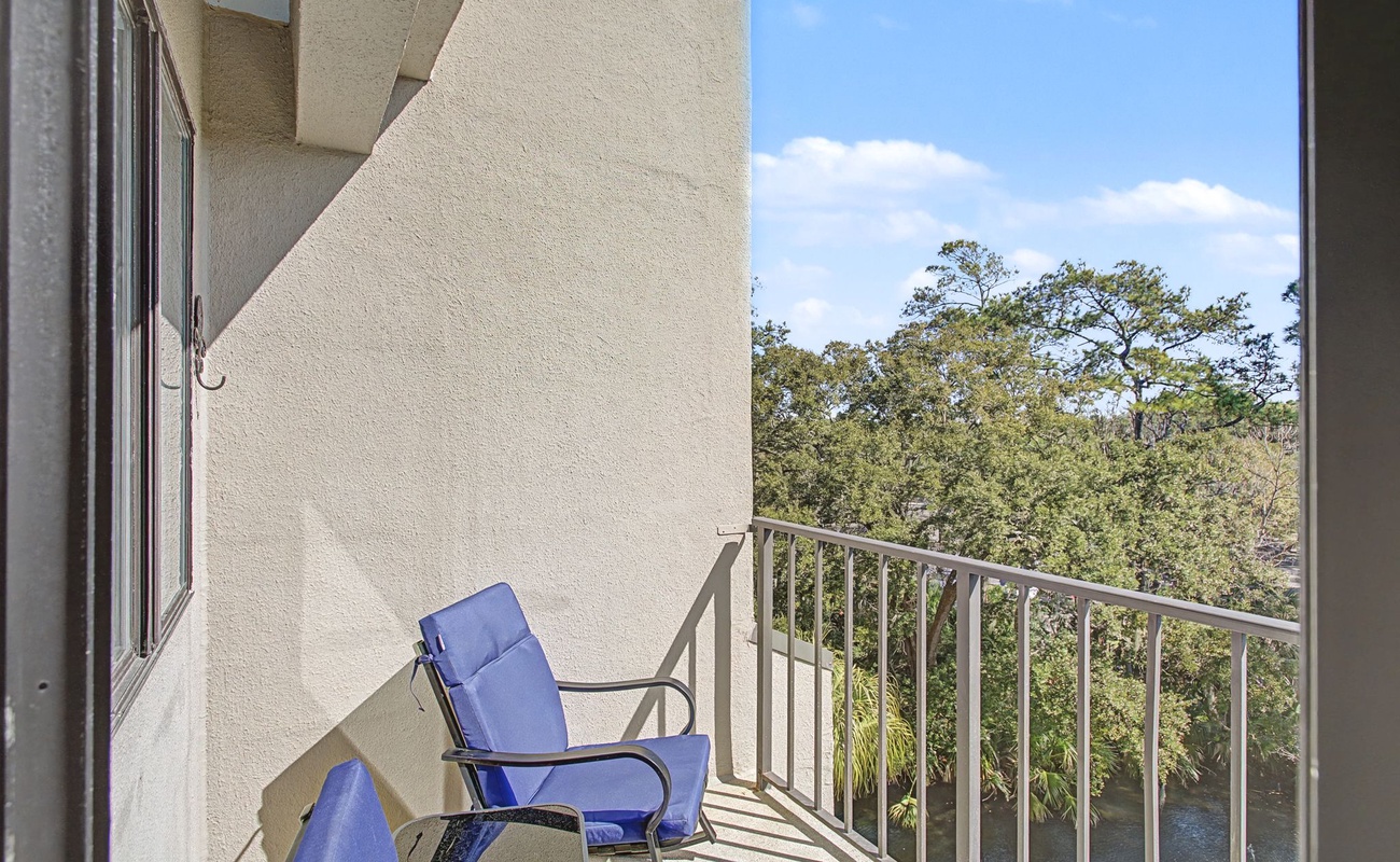 Step onto your private balcony and settle into comfortable seating while enjoying peaceful treetop views and fresh air.