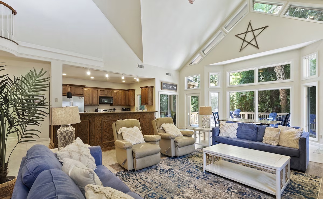 Relax in your spacious living area with soaring ceilings, abundant natural light, and comfortable seating perfect for gathering.