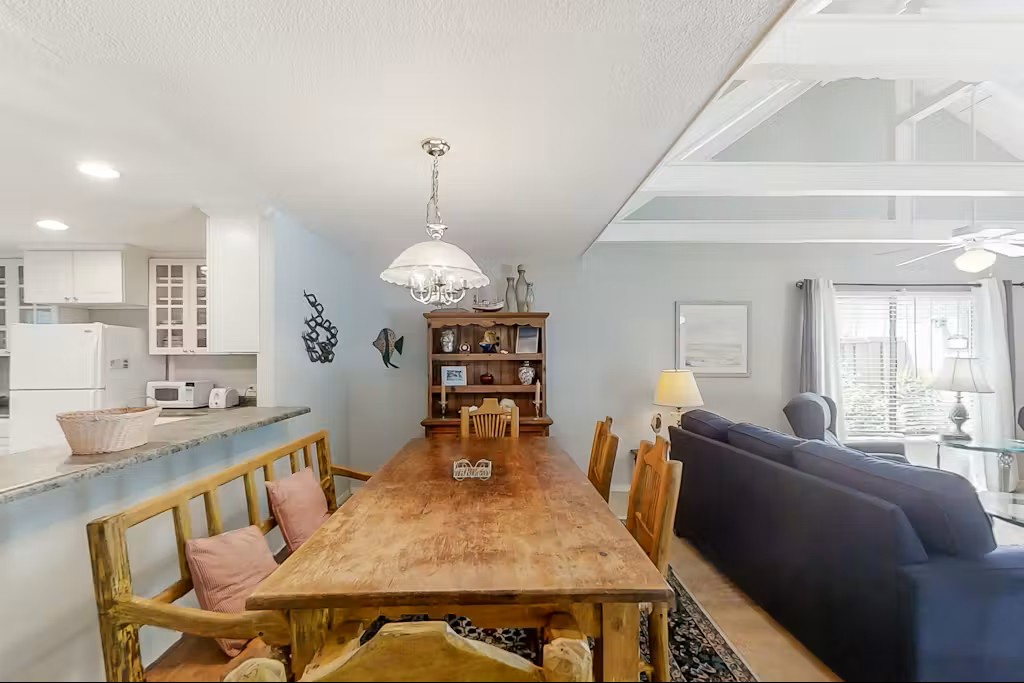 You'll love gathering around this beautiful wooden dining table, perfect for family meals and vacation planning sessions.