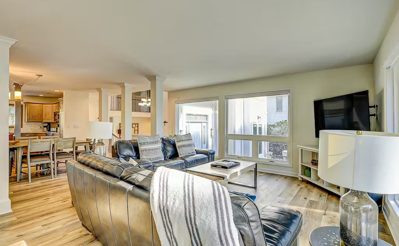 Unwind in your spacious living room with plush leather seating and natural light streaming through large windows.