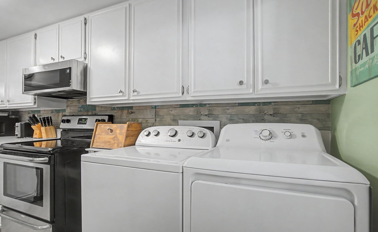 Your fully equipped kitchen and laundry area features stainless steel appliances and ample cabinet storage for your convenience.