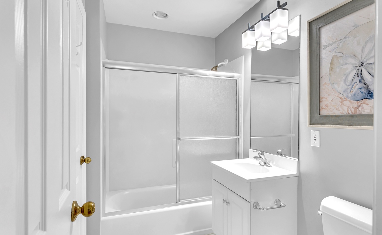 Step into your elegant bathroom featuring a glass-enclosed shower-tub combo, contemporary lighting, and spa-like touches for your daily retreat.