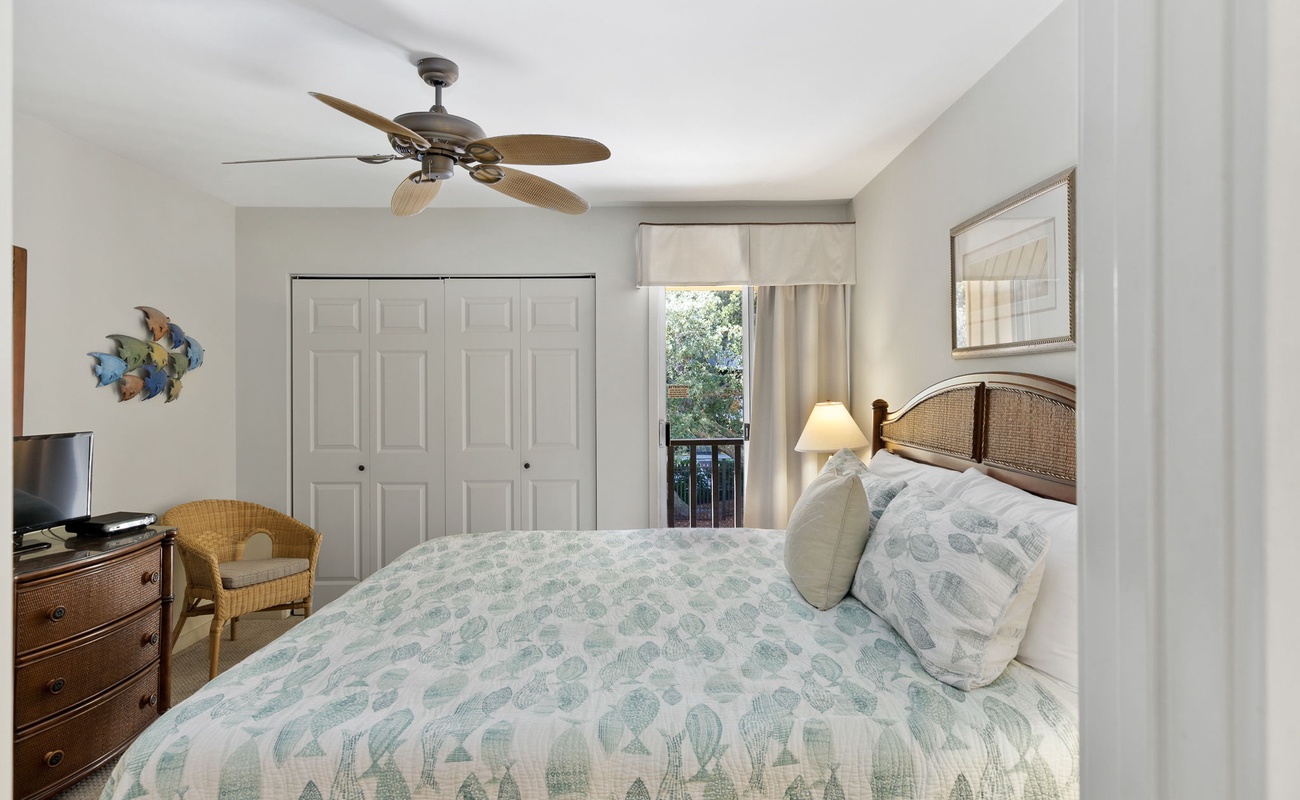 Drift off to sleep in your peaceful bedroom with coastal charm, complete with ceiling fan and garden views.