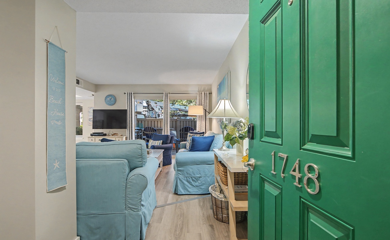 Step into your coastal retreat with cheerful blue furnishings and bright natural light streaming through the windows.