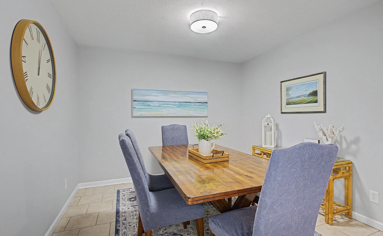 Gather around this elegant dining table for memorable meals together, with coastal artwork creating a serene backdrop for your conversations.