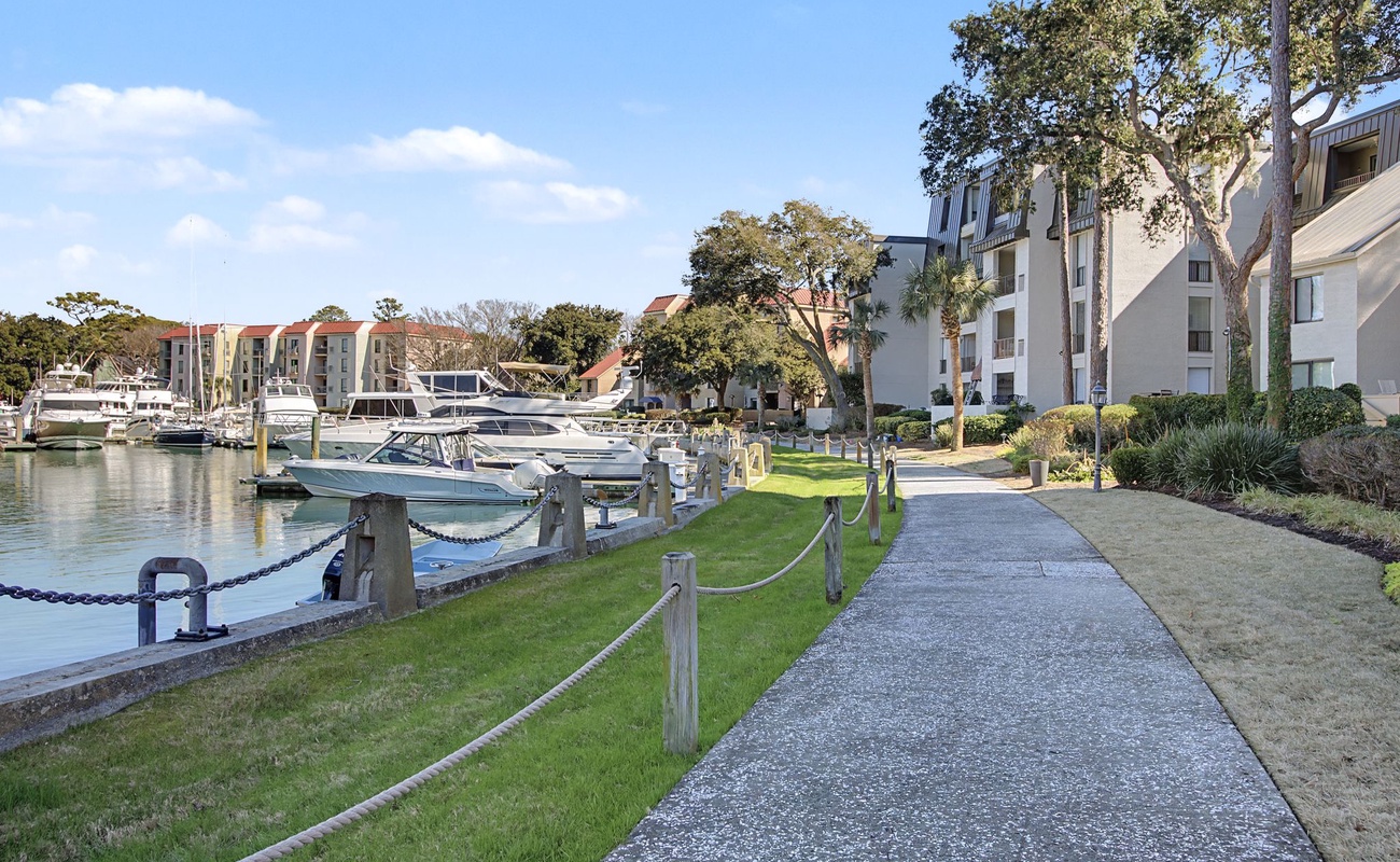 Waterfront property with marina access, landscaped grounds, and scenic walking paths along the harbor.