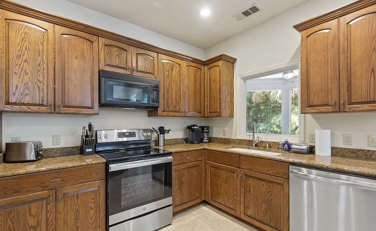 Your fully-equipped kitchen features warm wood cabinets, granite counters, and stainless appliances for memorable home-cooked meals.