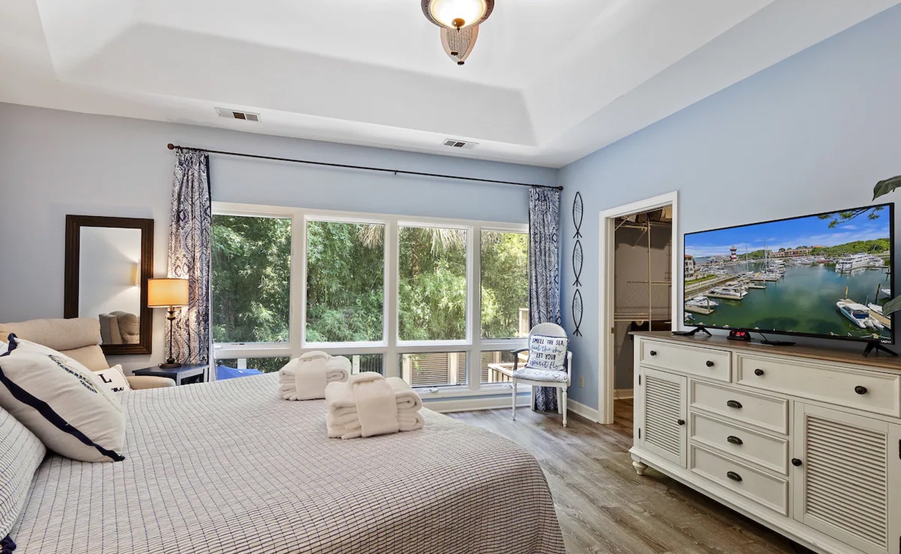 Sink into your coastal-themed master suite where soft blues and nautical touches create the perfect retreat after exploring the area.