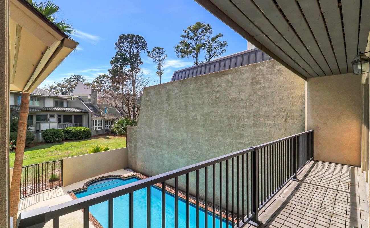 Step onto your private balcony and soak in the sparkling pool view below, where sun-dappled waters invite relaxation.