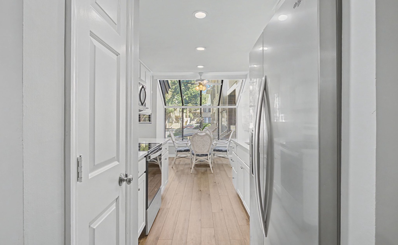 Your bright galley kitchen flows seamlessly to a cozy dining nook, where morning coffee tastes better with garden views.