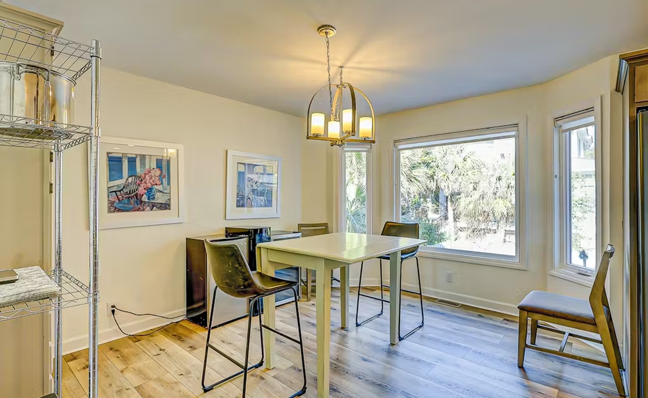 Gather around your bright dining table with garden views streaming through large windows, creating the perfect spot for morning coffee and evening meals.