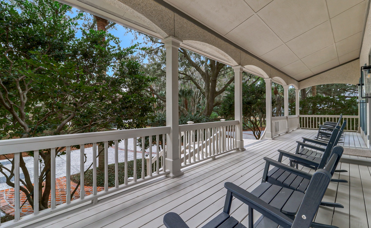 Relax in your private rocking chairs on this spacious covered porch, surrounded by lush tropical greenery and gentle shade.