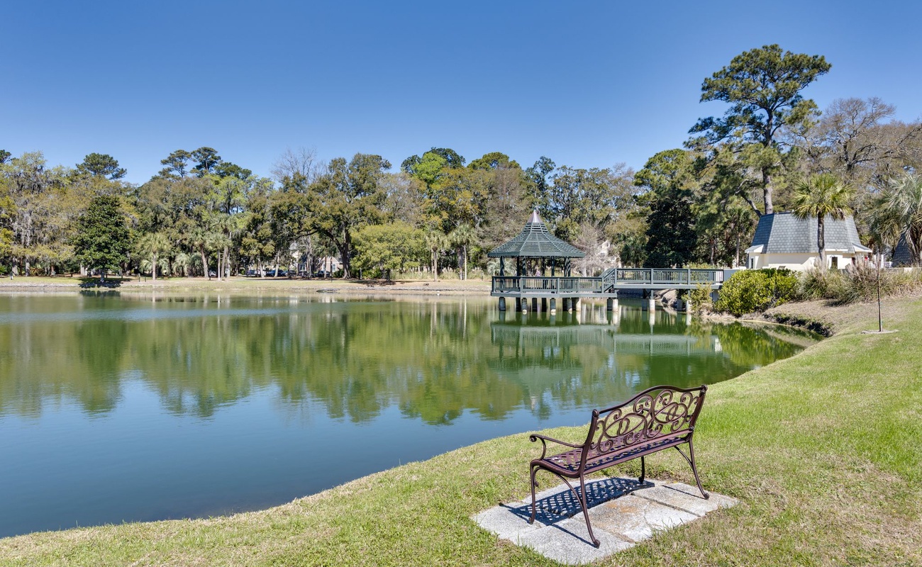 Peaceful lakeside park with gazebo and walking paths creates a serene neighborhood setting near the property.