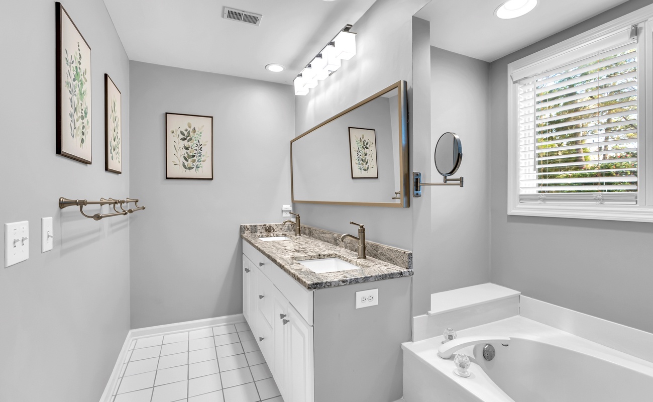Your spa-inspired bathroom blends modern elegance with serene comfort, featuring granite counters and a soaking tub for ultimate relaxation.