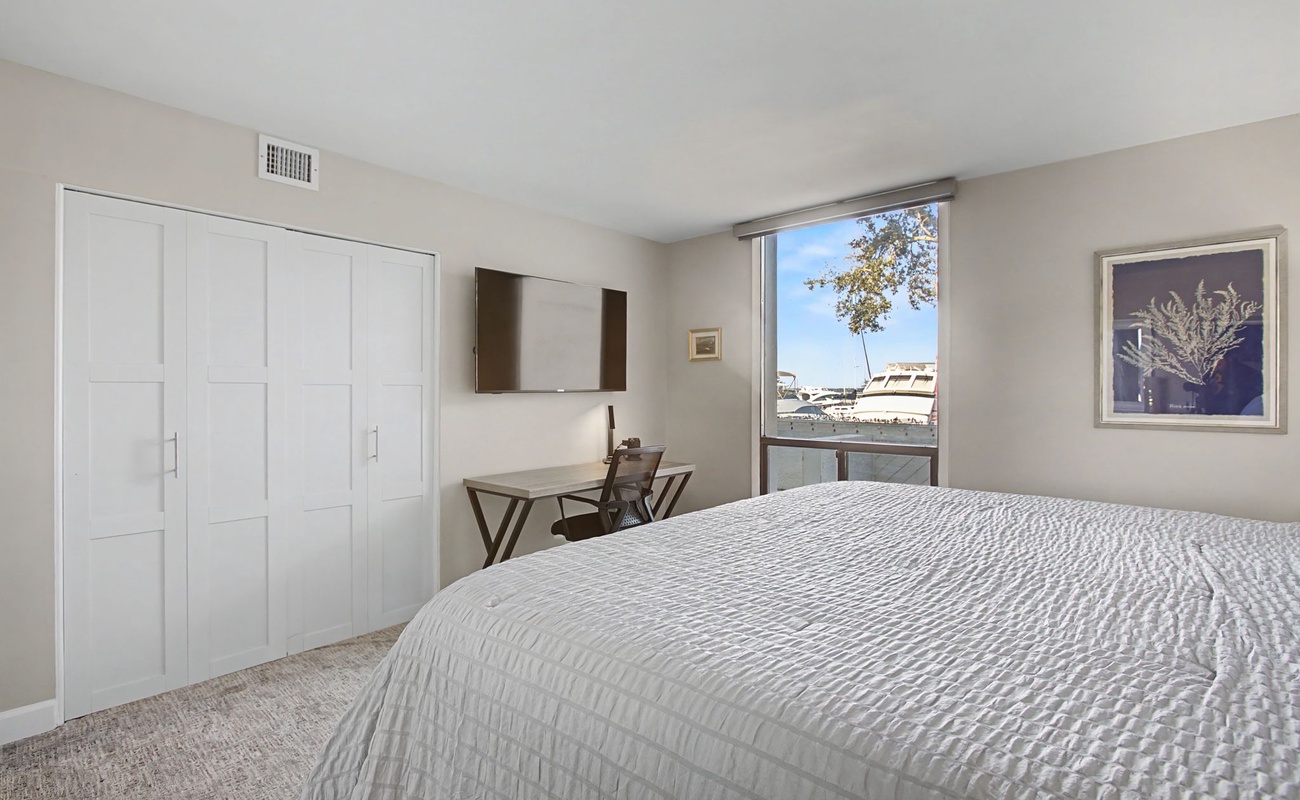 Wake up to natural light streaming through your window in this serene bedroom with ample storage and a dedicated workspace for your comfort.
