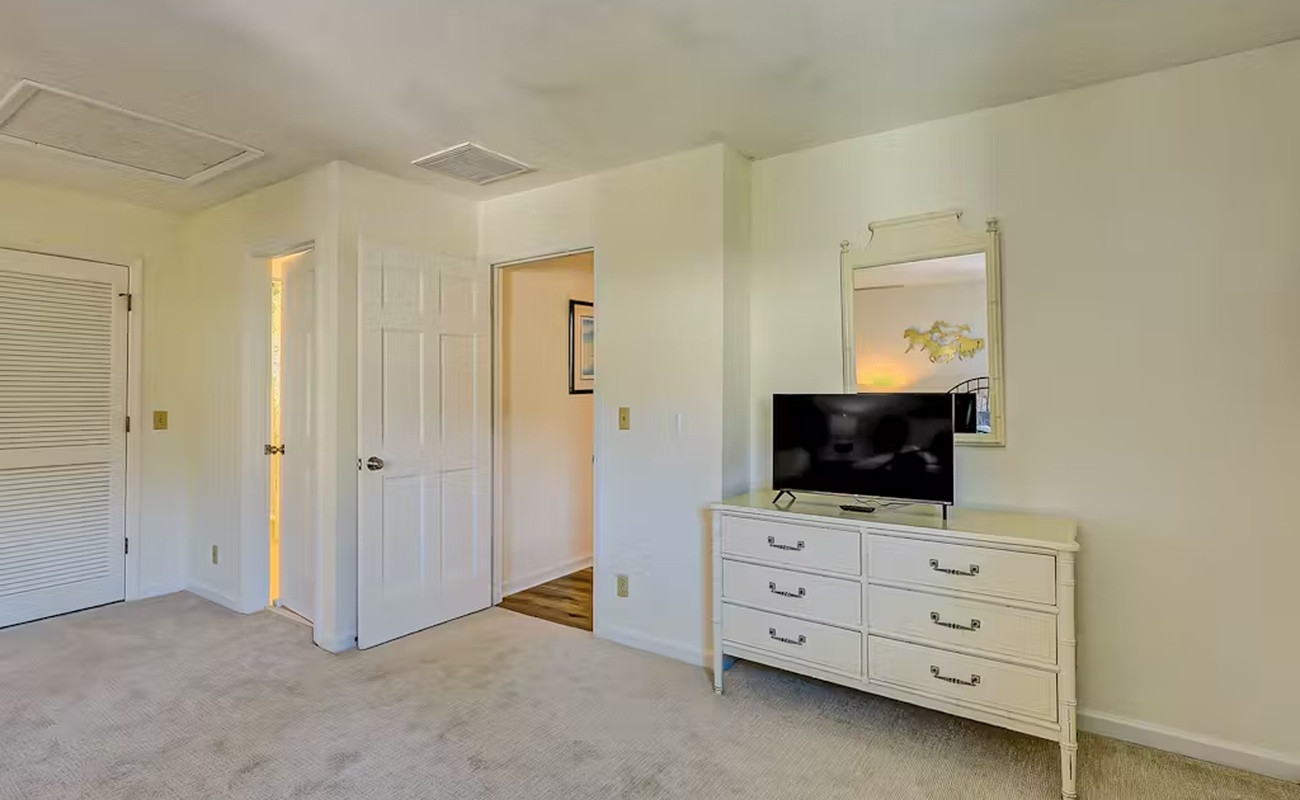 Your bedroom features a spacious dresser with flat-screen TV and ample storage for all your belongings during your stay.