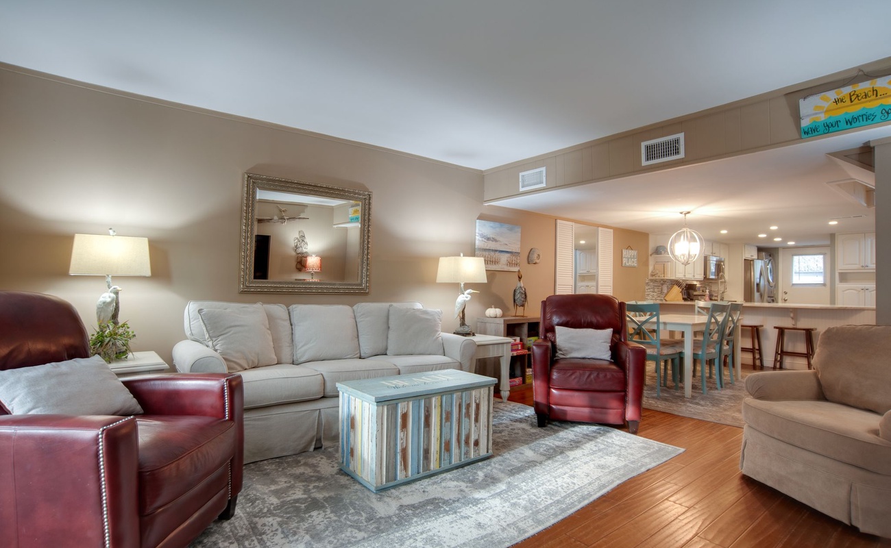 Sink into plush seating where warm lighting and rich leather create your perfect retreat for movie nights and morning coffee.