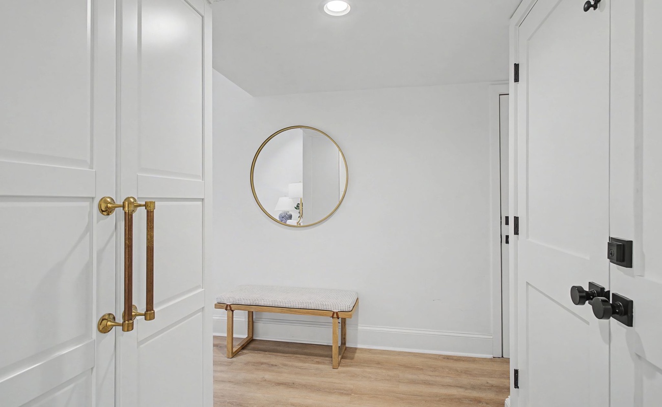 Step into your private sanctuary with elegant brass details and warm wood floors welcoming you home.